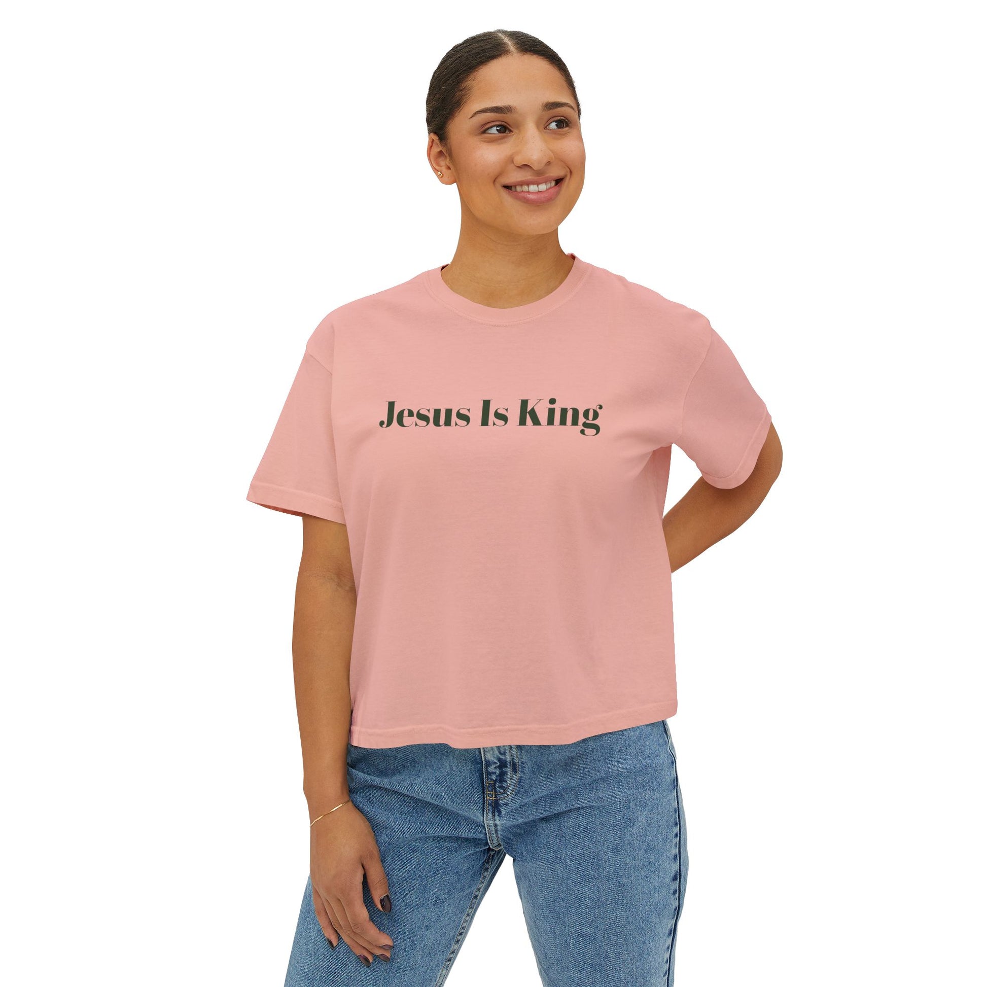 Person wearing a pink t-shirt with 'Jesus Is King' text on a white background