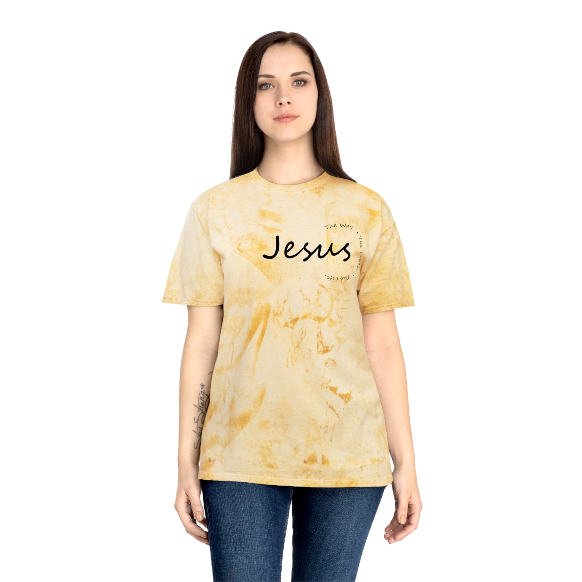 Person wearing a yellow tie-dye t-shirt with 'Jesus' printed on it against a white background