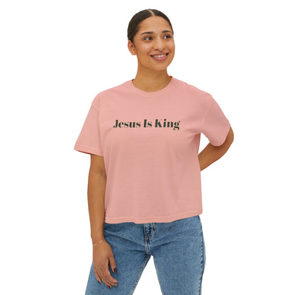Person wearing a pink t-shirt with 'Jesus Is King' text on a white background