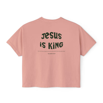 Pink t-shirt with 'Jesus is King' text on a white background