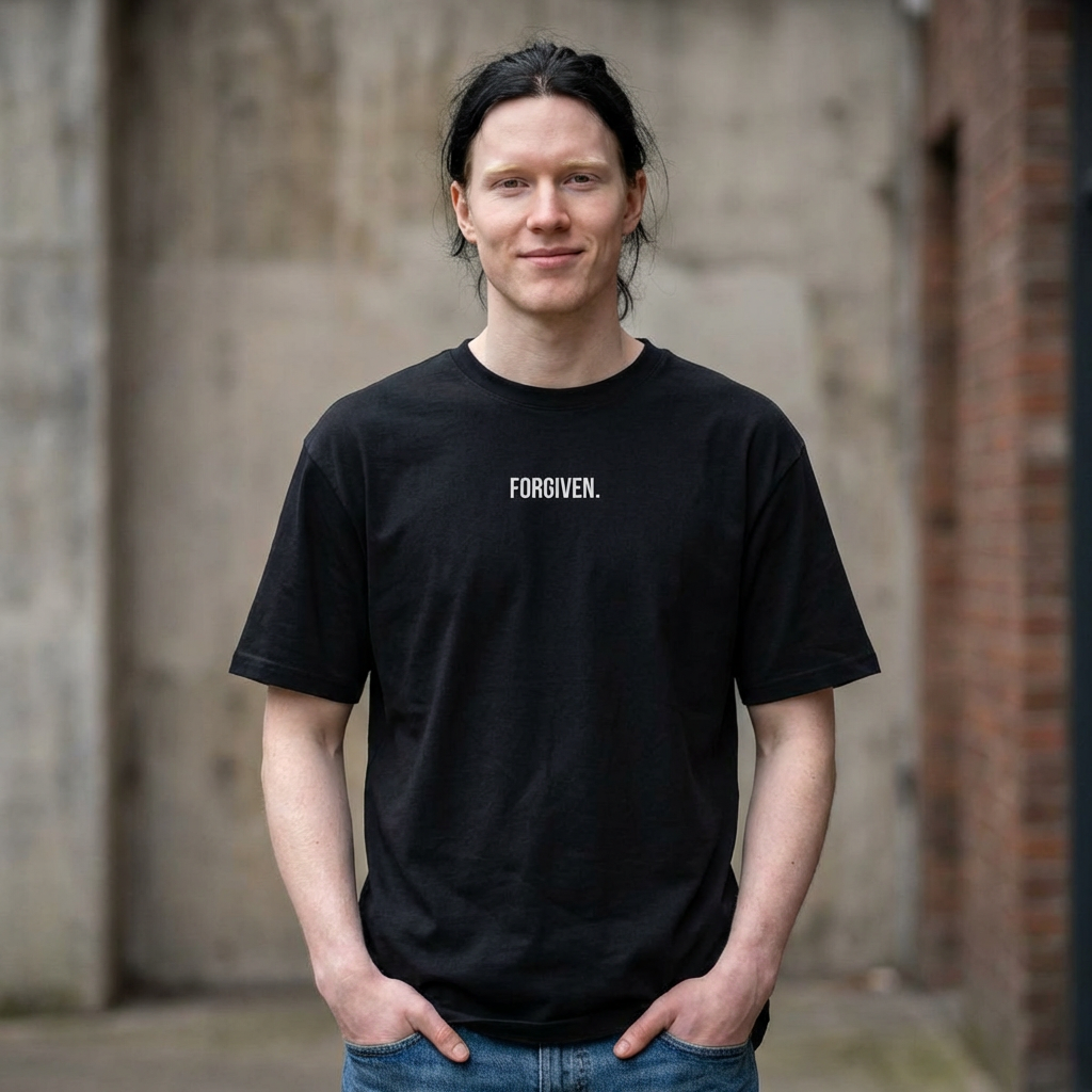 Close-up of Forgiven Still Dangerous Christian streetwear tee in black showing high-neck Forgiven text placement.