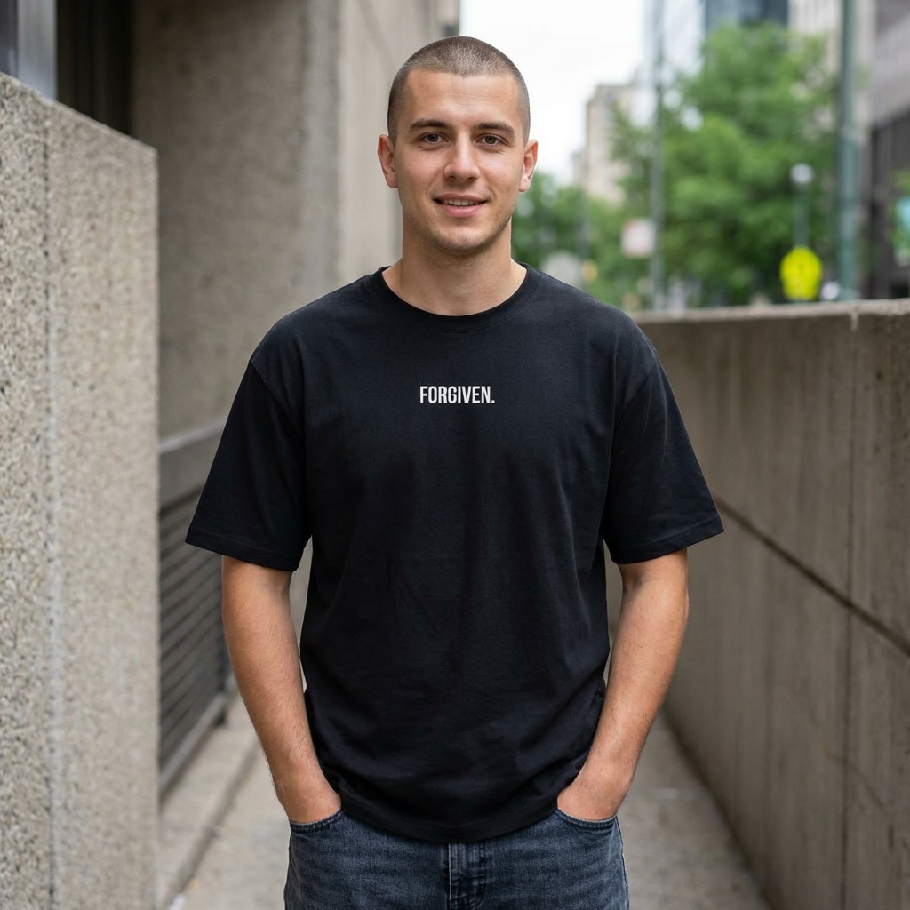 Close-up of Forgiven Still Dangerous Christian streetwear tee in black showing high-neck Forgiven text placement.
