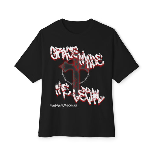 Muscular man with military haircut wearing Grace Made Me Lethal Christian streetwear t-shirt in urban alley

