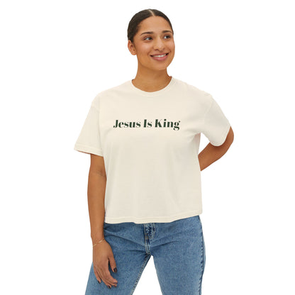 Person wearing a white t-shirt with 'Jesus Is King' text on a white background